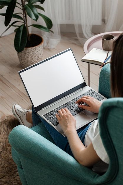 Premium Photo | Young woman using laptop screen blank mock up work home